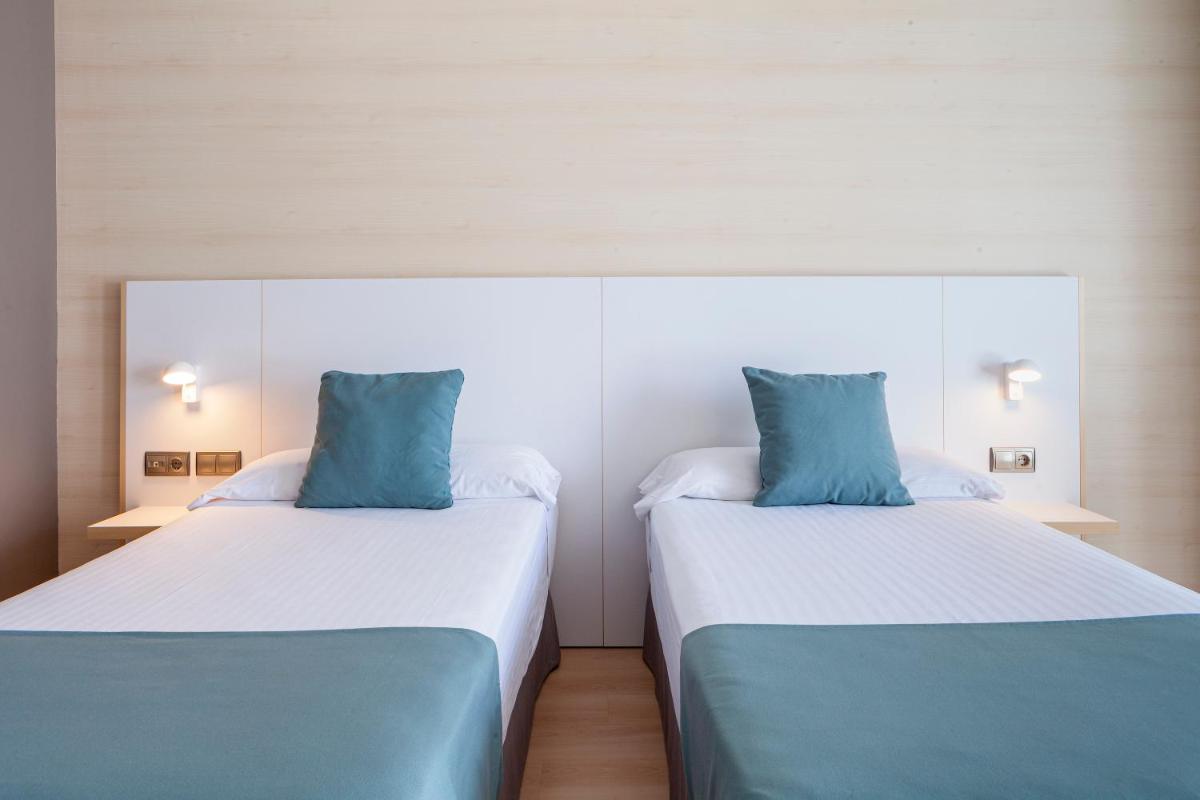 Cama o camas de una habitación en Hotel Olympia Valencia