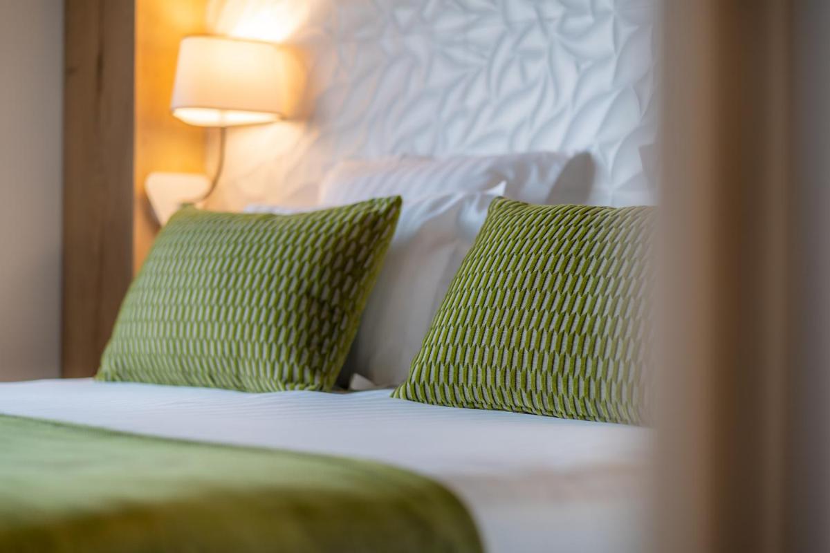 Un ou plusieurs lits dans un hébergement de l'établissement Mildiss Hotel Spa & Restaurant, BW Signature Collection