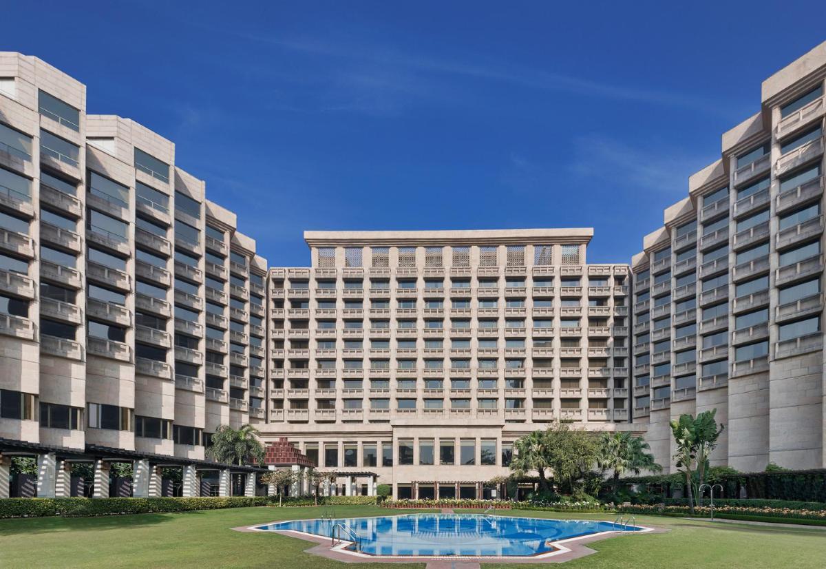 a large building with a pool in front of it at Hyatt Regency Delhi in New Delhi a large building with a pool in front of it at Hyatt Regency Delhi in New Delhi