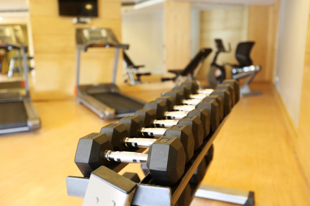 a row of exercise bikes in a gym at Golden Tulip Jaipur in Jaipur