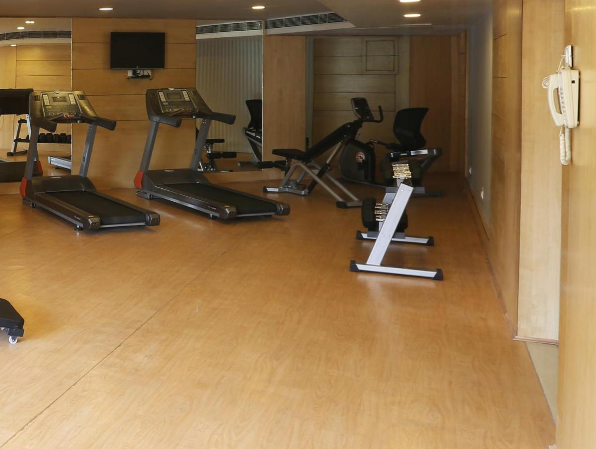 a gym with several exercise bikes in a room at Golden Tulip Jaipur in Jaipur