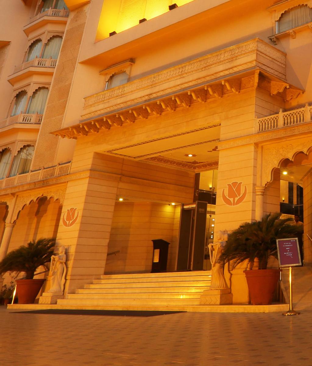 a large building with stairs in front of it at Golden Tulip Jaipur in Jaipur