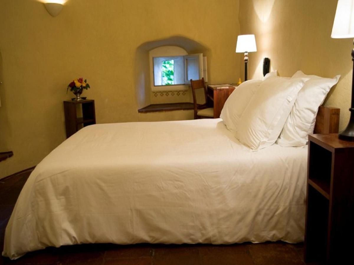 Un ou plusieurs lits dans un hébergement de l'établissement Hotel La Bougnate