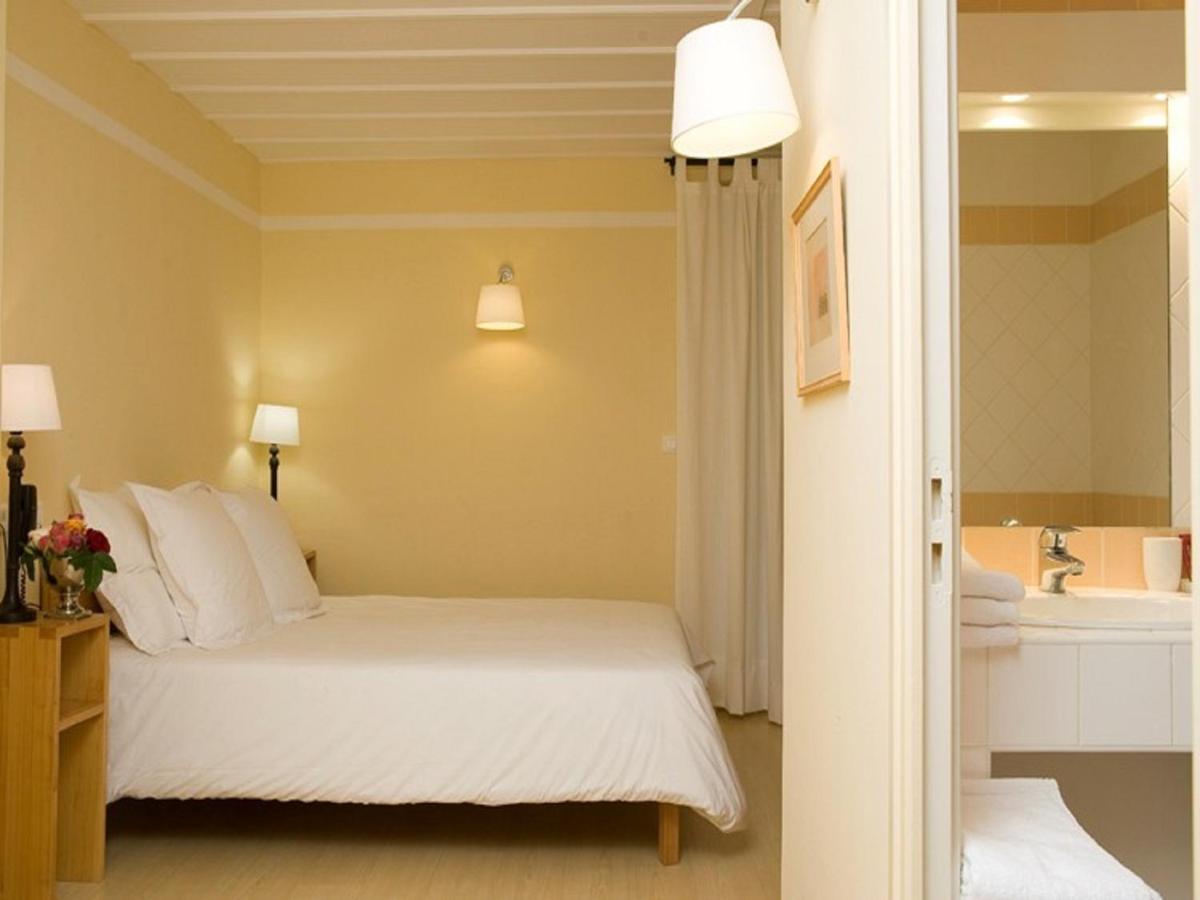 Un ou plusieurs lits dans un hébergement de l'établissement Hotel La Bougnate