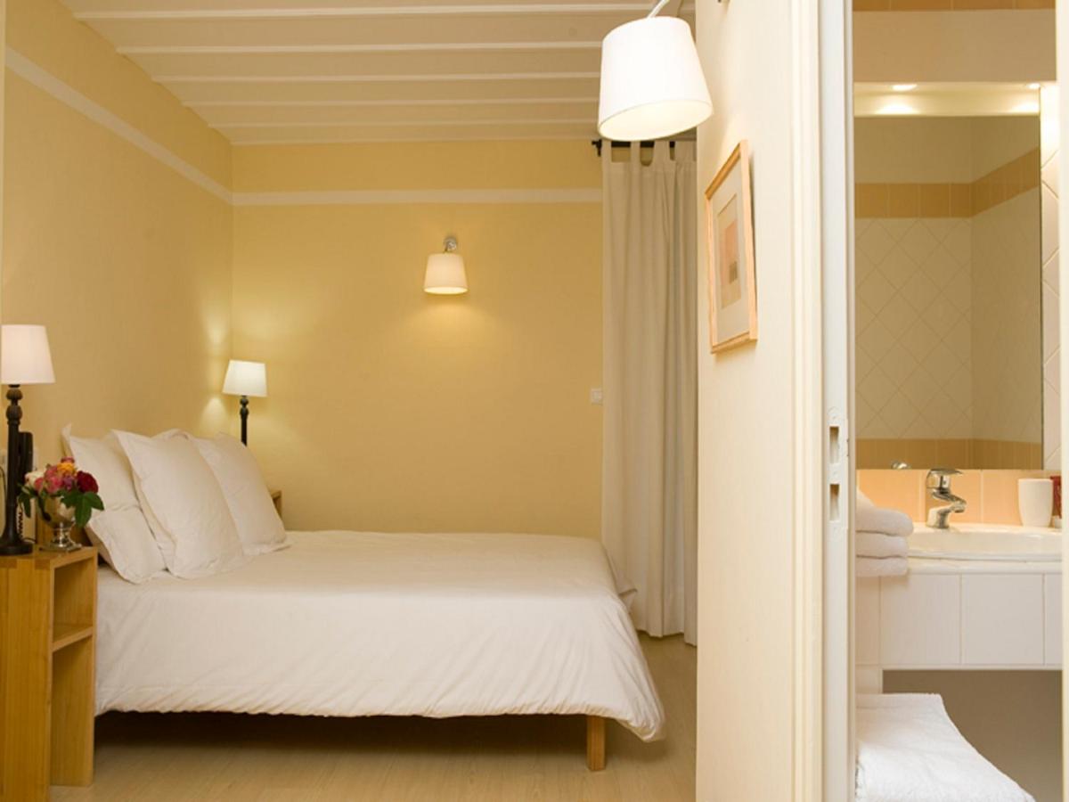 Un ou plusieurs lits dans un hébergement de l'établissement Hotel La Bougnate