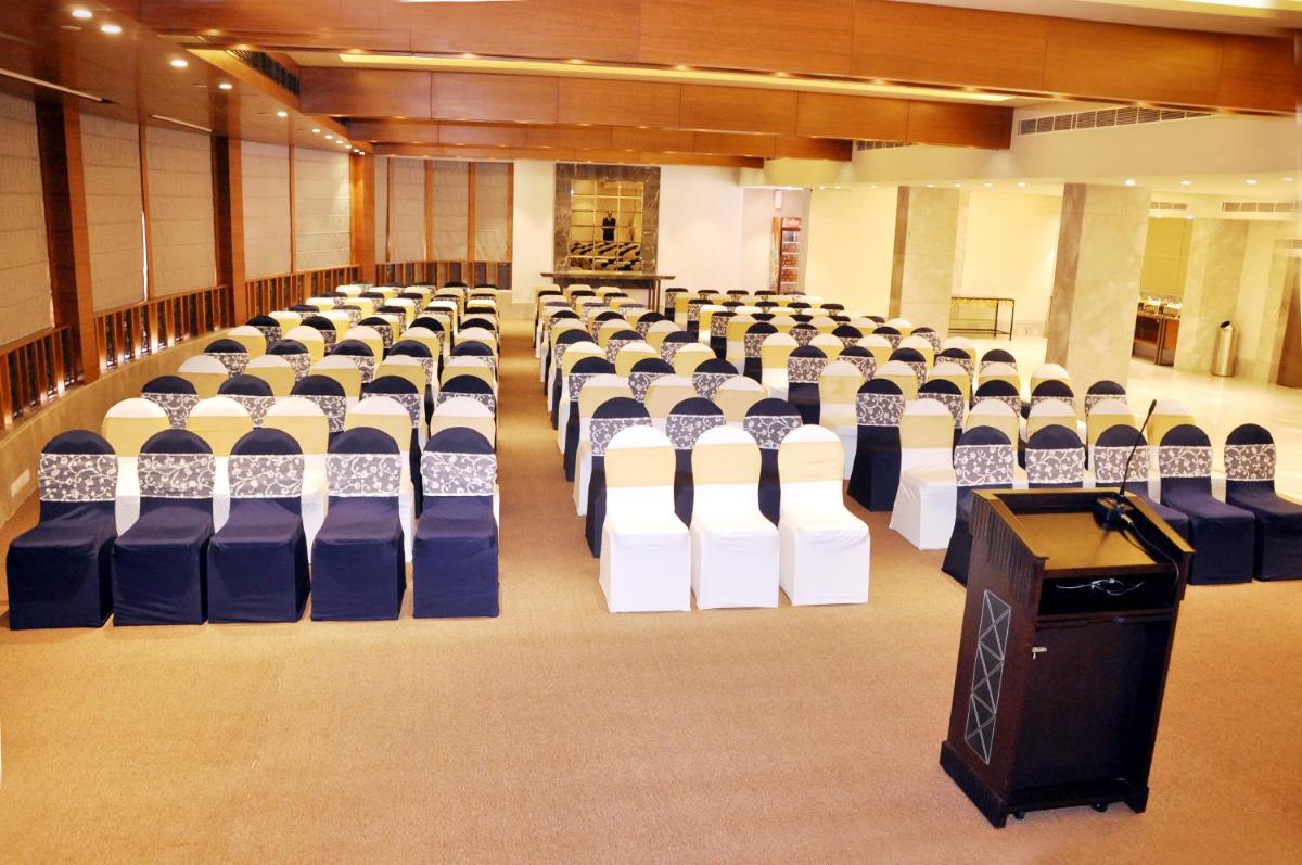 a hall with rows of chairs and a podium at Radisson Hotel Shimla in Shimla