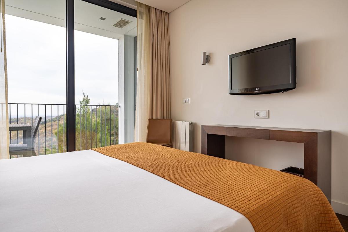 Uma cama ou camas num quarto em Monchique Resort & Spa