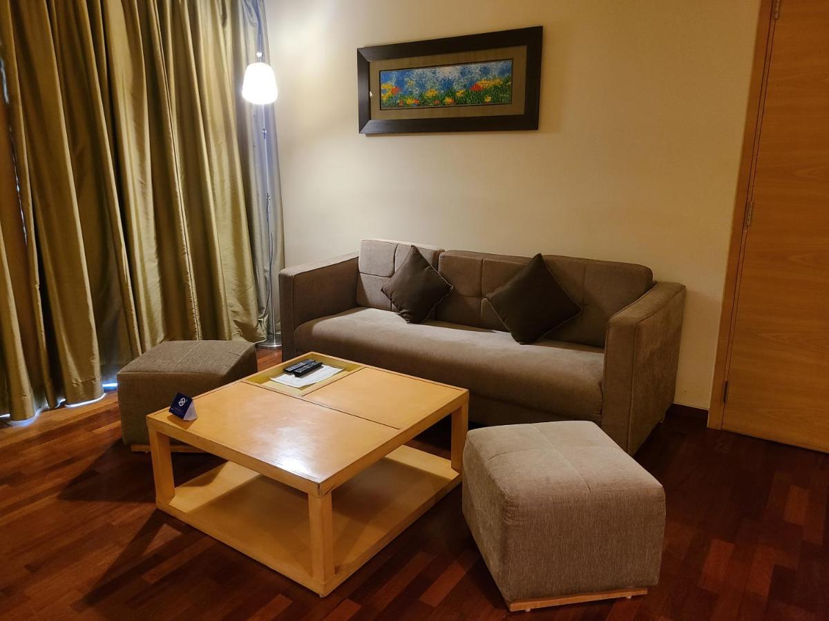a living room with a couch and a coffee table at Novotel Hyderabad Airport in Hyderabad