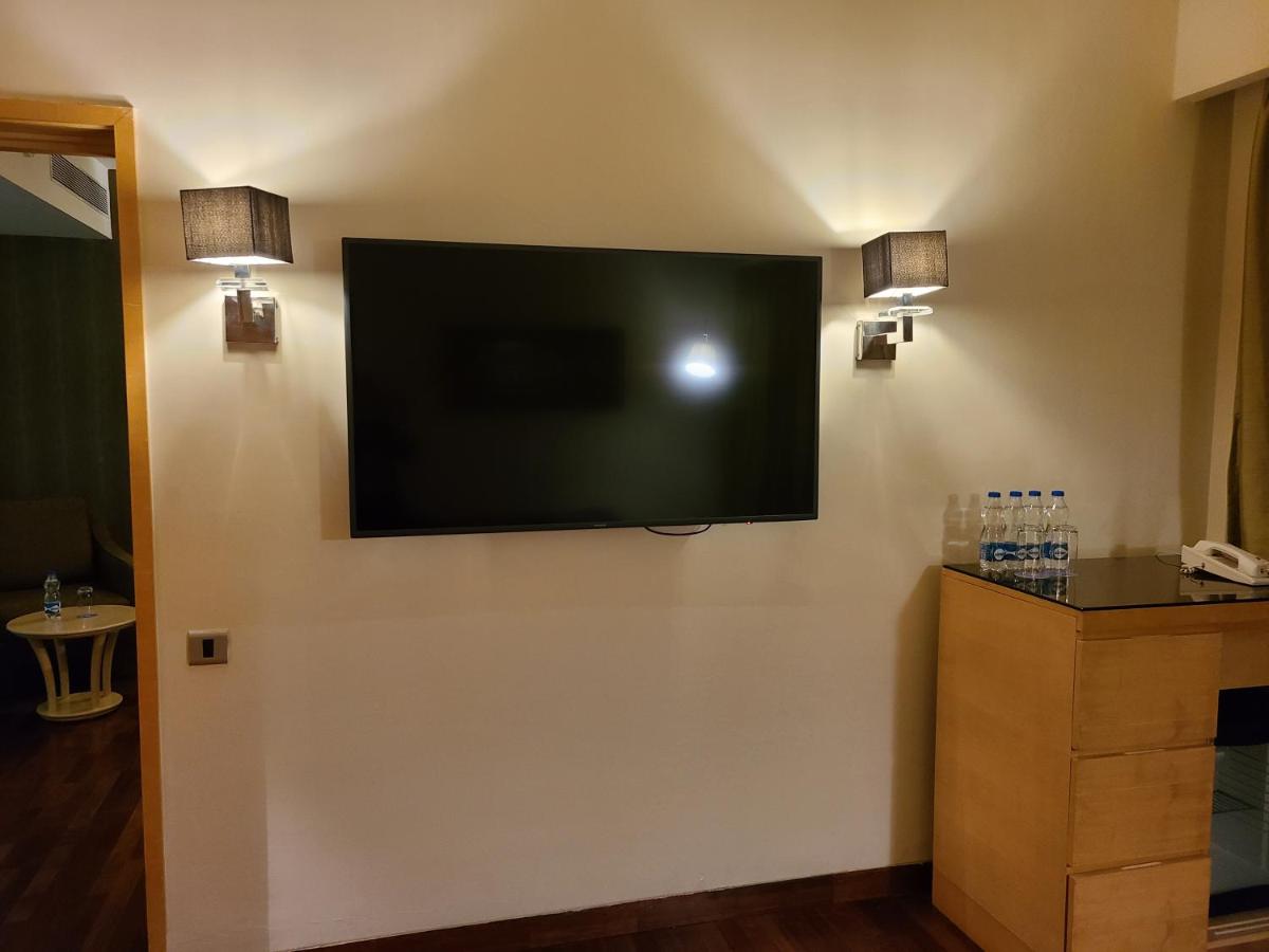 a flat screen tv on the wall of a hotel room at Novotel Hyderabad Airport in Hyderabad
