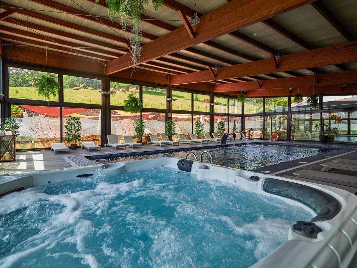 Habitación grande con ventanas y bañera de hidromasaje grande. en La Piconera Hotel & Spa, en Ribadesella