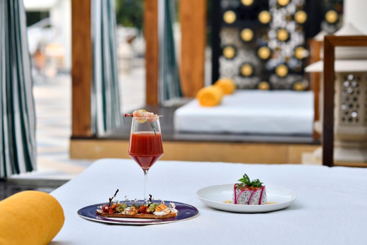 a table with a plate of food and a drink at Taj Mahal, New Delhi in New Delhi