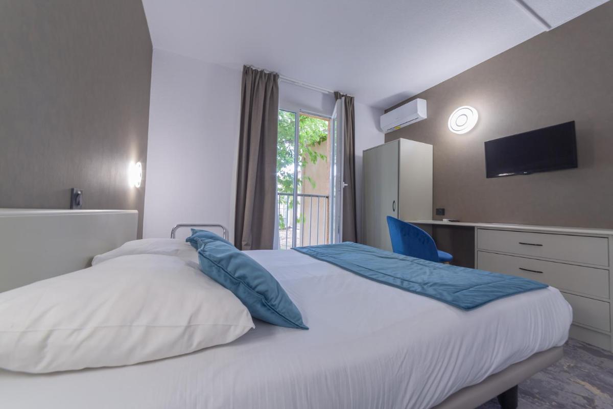 Un ou plusieurs lits dans un hébergement de l'établissement Relax'Otel & Spa, Le Barcarès