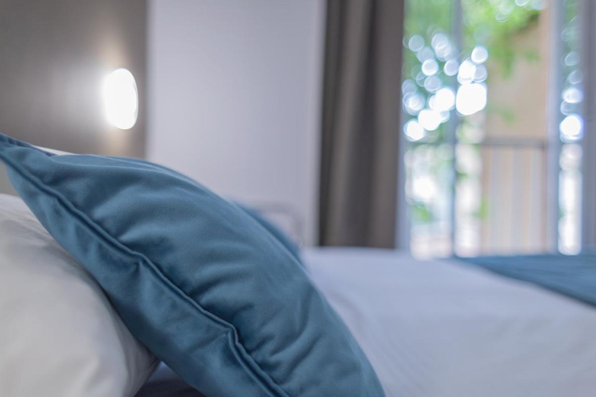 Un ou plusieurs lits dans un hébergement de l'établissement Relax'Otel & Spa, Le Barcarès