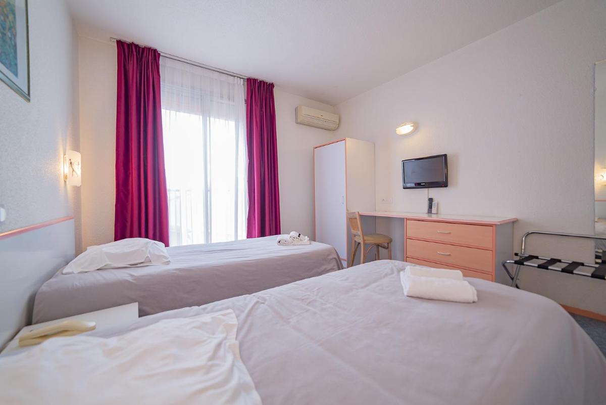 Un ou plusieurs lits dans un hébergement de l'établissement Relax'Otel & Spa, Le Barcarès