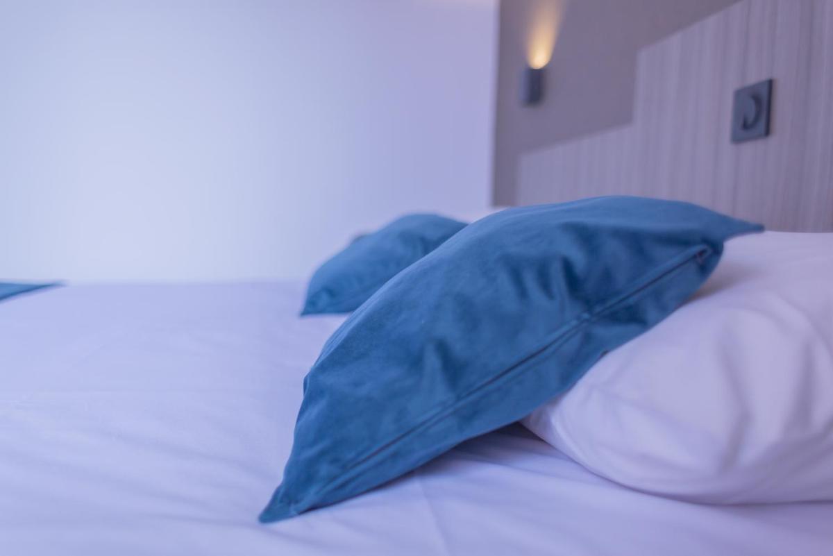 Un ou plusieurs lits dans un hébergement de l'établissement Relax'Otel & Spa, Le Barcarès