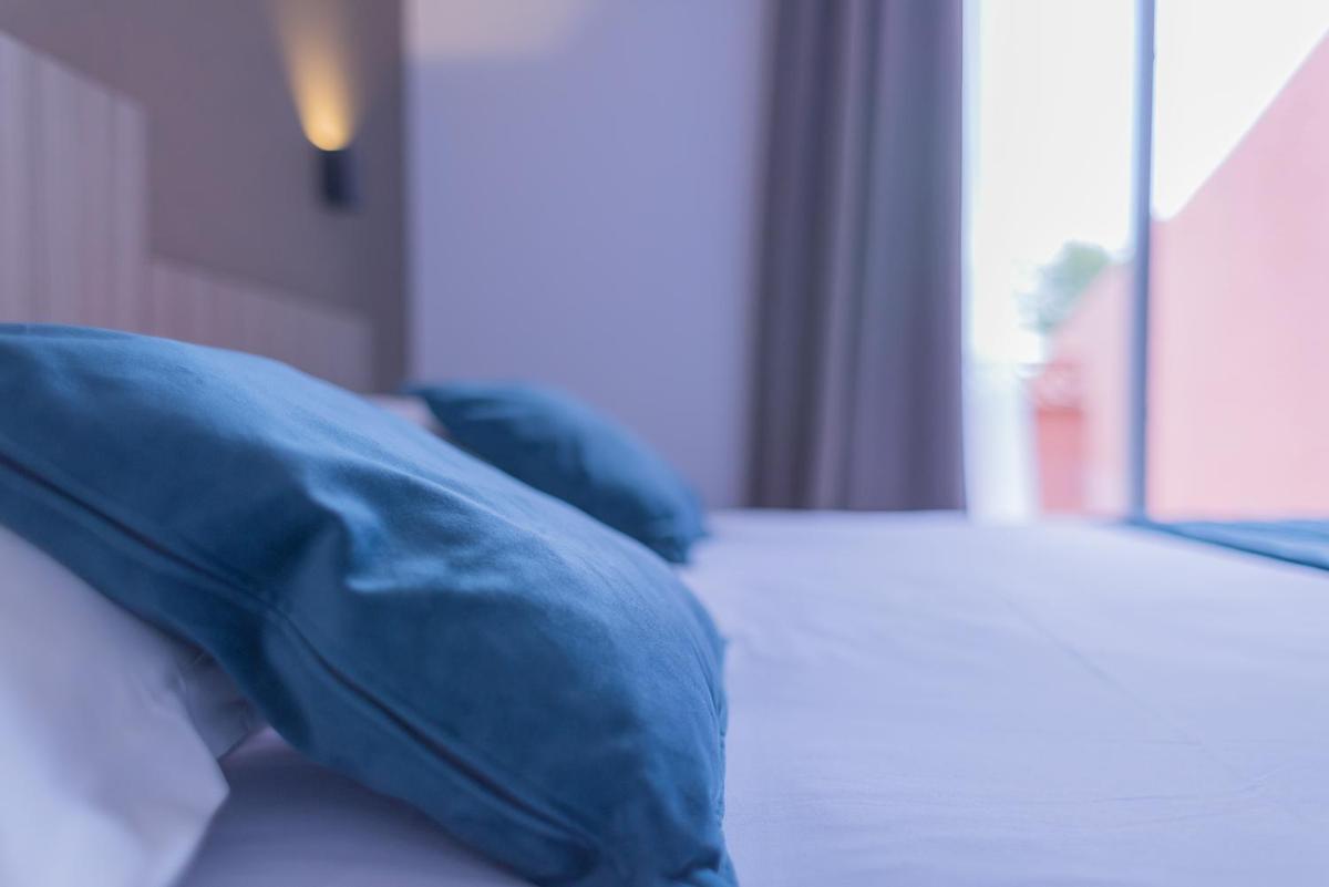 Un ou plusieurs lits dans un hébergement de l'établissement Relax'Otel & Spa, Le Barcarès
