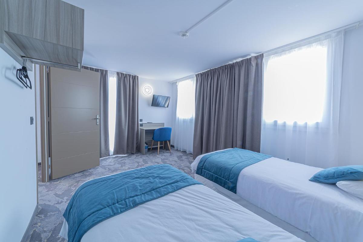 Un ou plusieurs lits dans un hébergement de l'établissement Relax'Otel & Spa, Le Barcarès