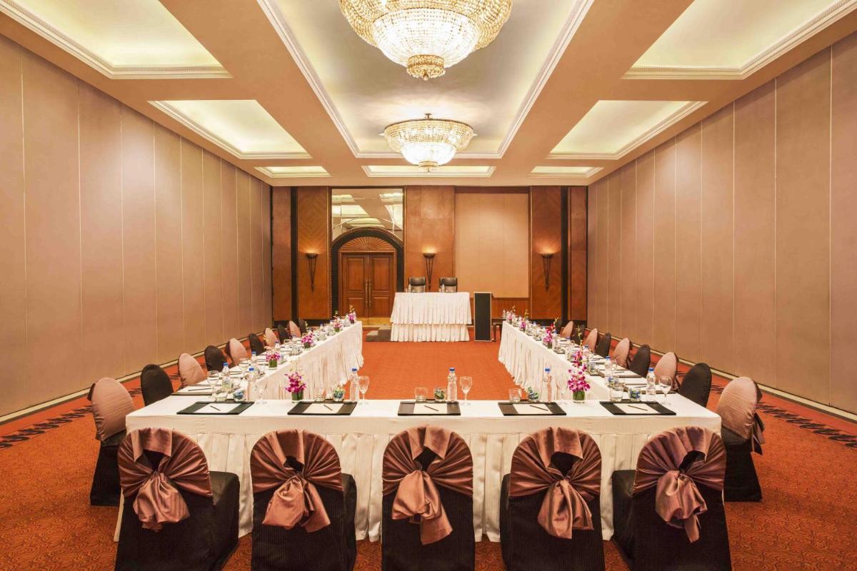 a large banquet room with tables and chairs in it at Eros Hotel New Delhi, Nehru Place in New Delhi a large banquet room with tables and chairs in it at Eros Hotel New Delhi, Nehru Place in New Delhi