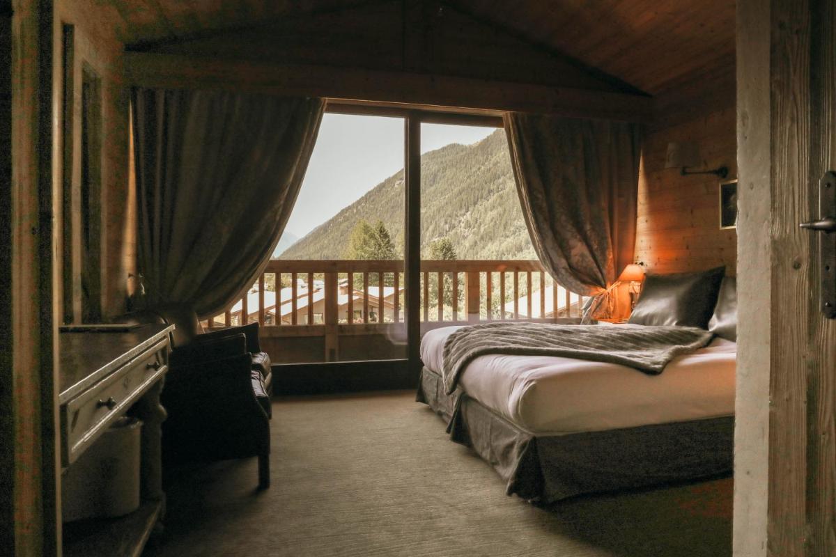 une chambre avec un lit et une vue sur une montagne dans l'établissement Les Grands Montets Hotel & Spa, à Chamonix-Mont-Blanc