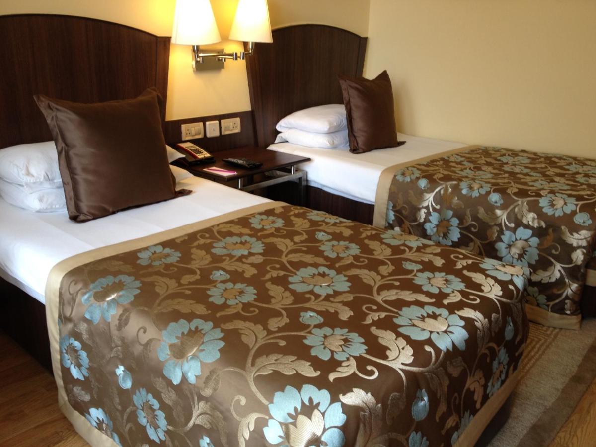 a hotel room with two beds in a room at Blue Diamond Pune IHCL SeleQtions in Pune