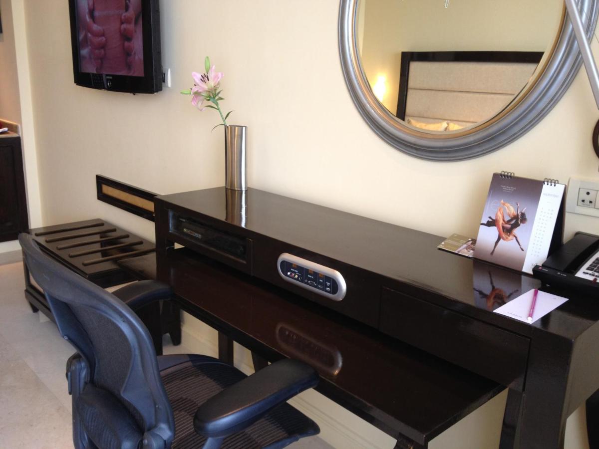 a desk in a room with a mirror at Blue Diamond Pune IHCL SeleQtions in Pune