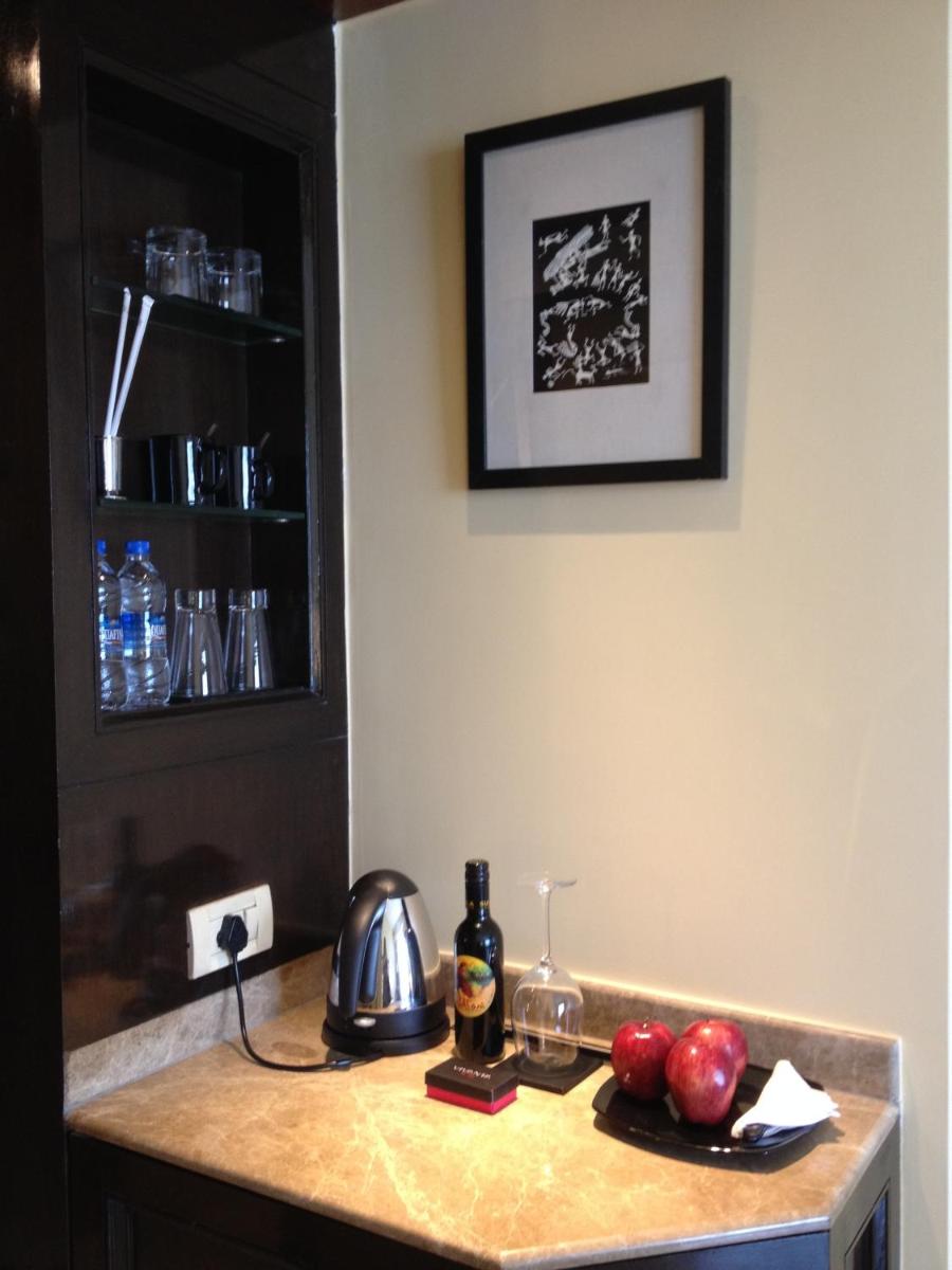 a kitchen counter with apples and a kettle on it at Blue Diamond Pune IHCL SeleQtions in Pune