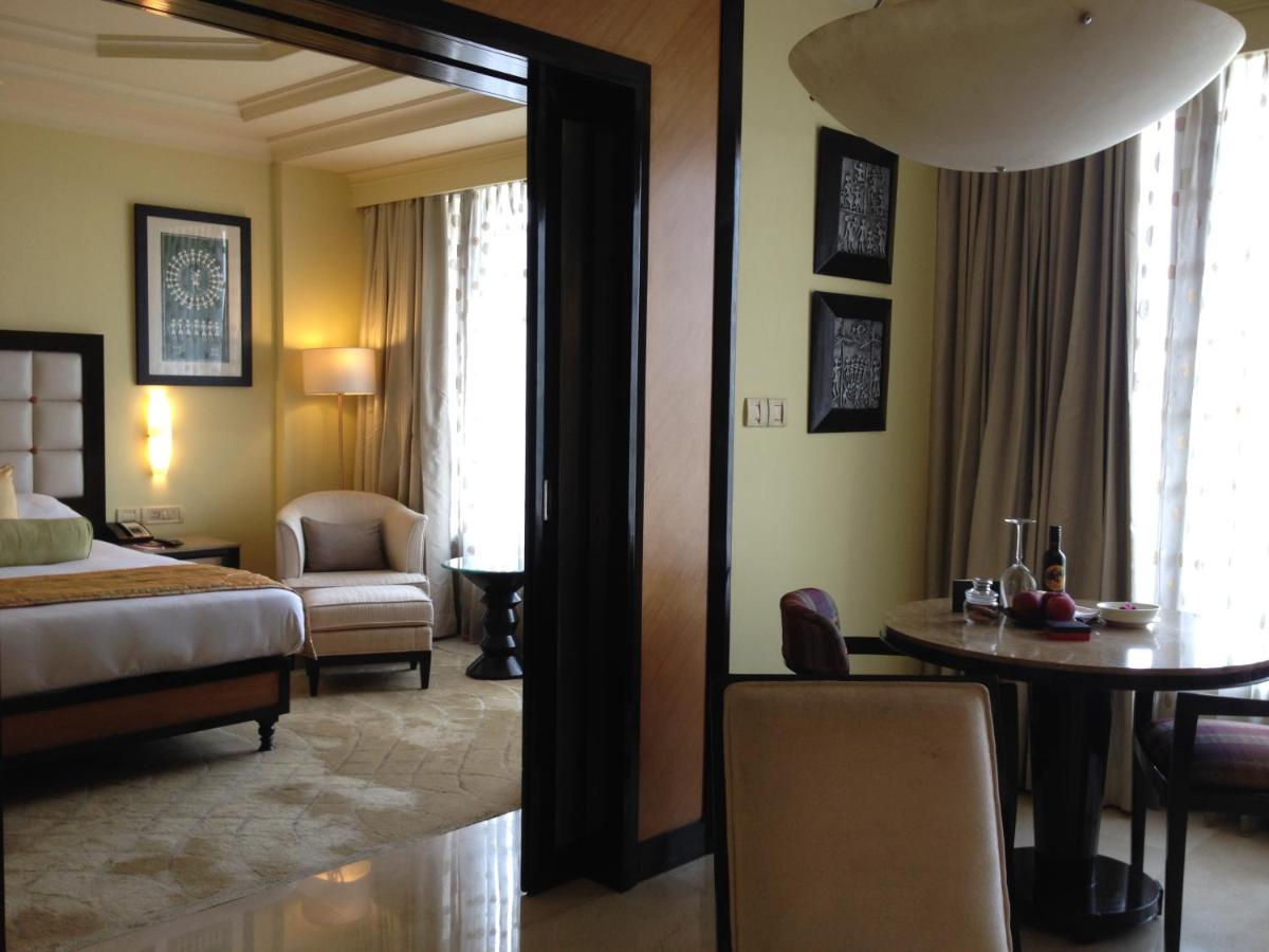 a hotel room with a bed and a table and a chair at Blue Diamond Pune IHCL SeleQtions in Pune