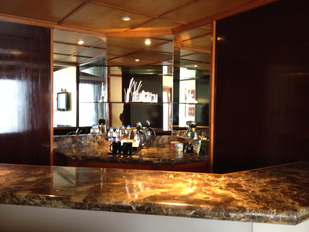 a bar in a hotel with a large mirror at Blue Diamond Pune IHCL SeleQtions in Pune