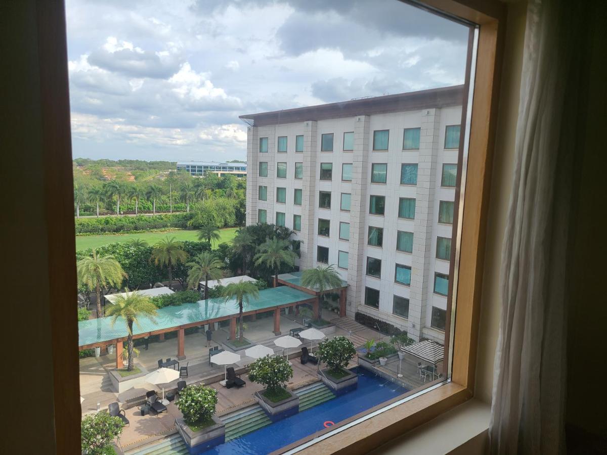 a view from a window of a hotel with a pool at Novotel Hyderabad Airport in Hyderabad