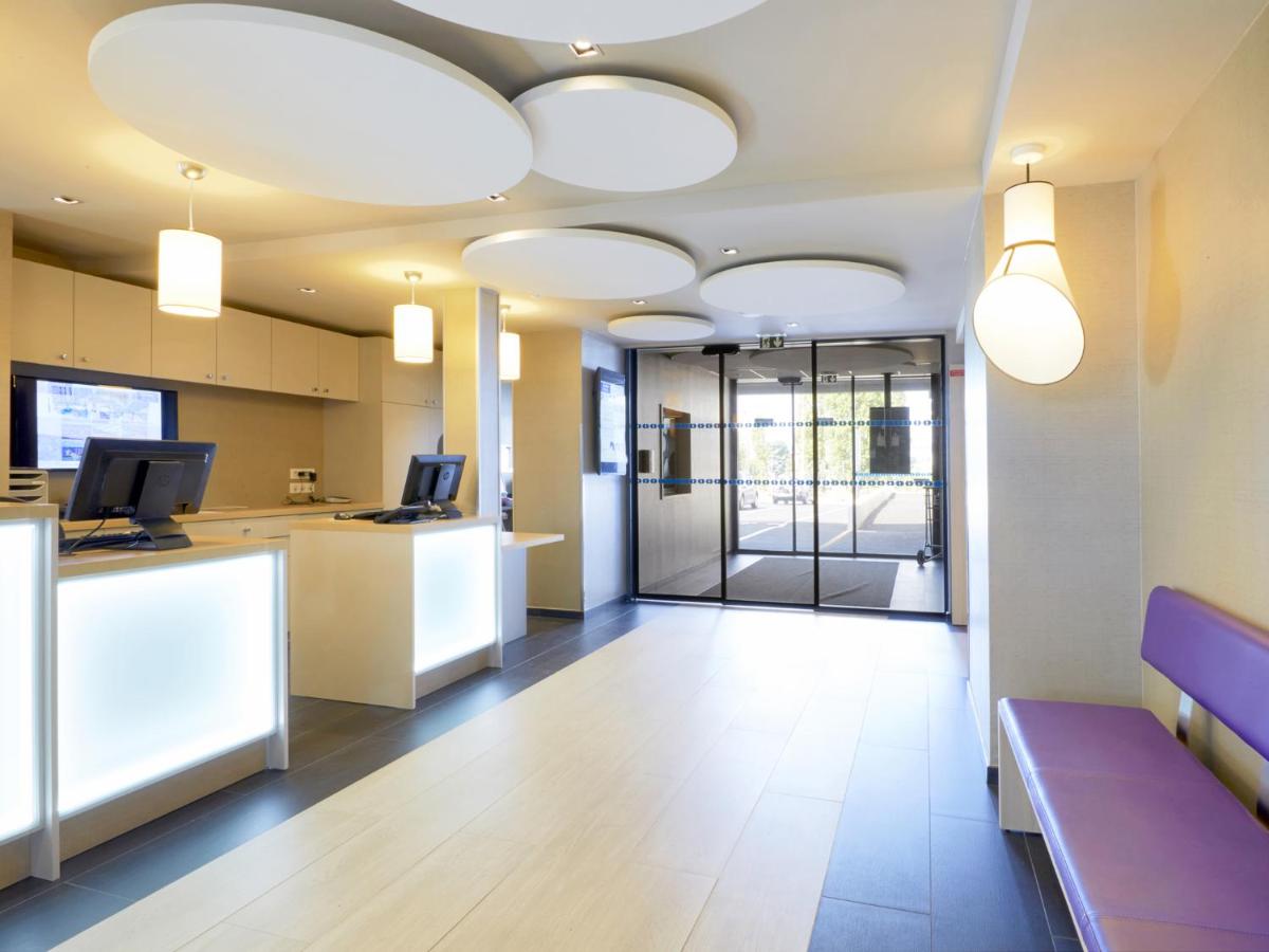 Télévision ou salle de divertissement dans l'établissement Kyriad Prestige Saint-Malo