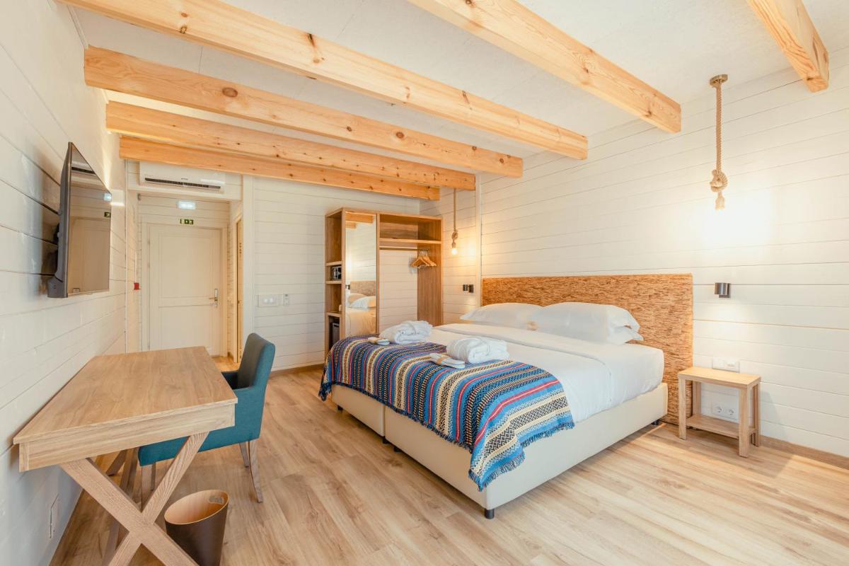 Uma cama ou camas num quarto em Sleep & Nature Hotel