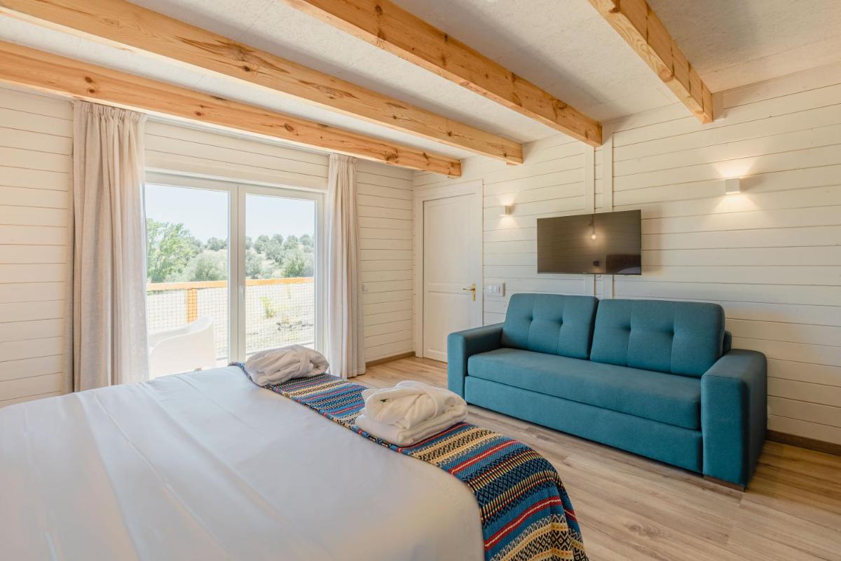 Uma cama ou camas num quarto em Sleep & Nature Hotel