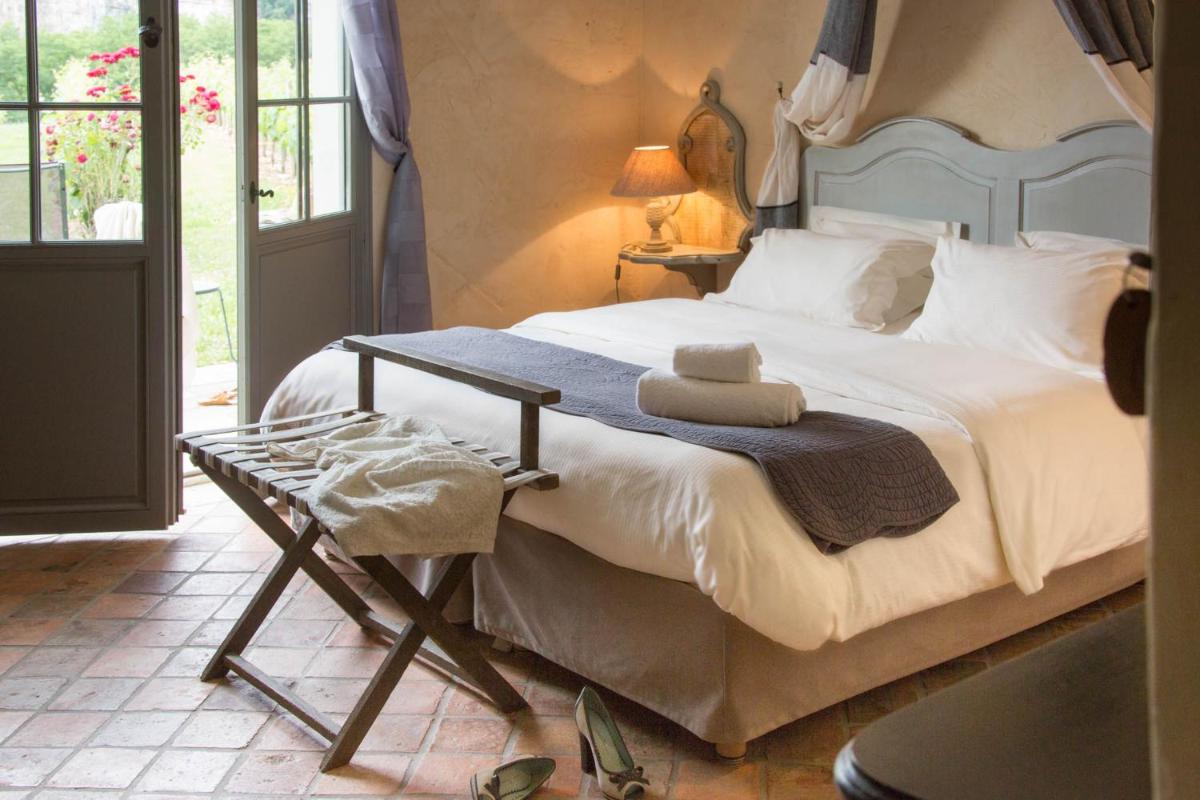 Un ou plusieurs lits dans un hébergement de l'établissement Hôtel-Spa Le Saint Cirq