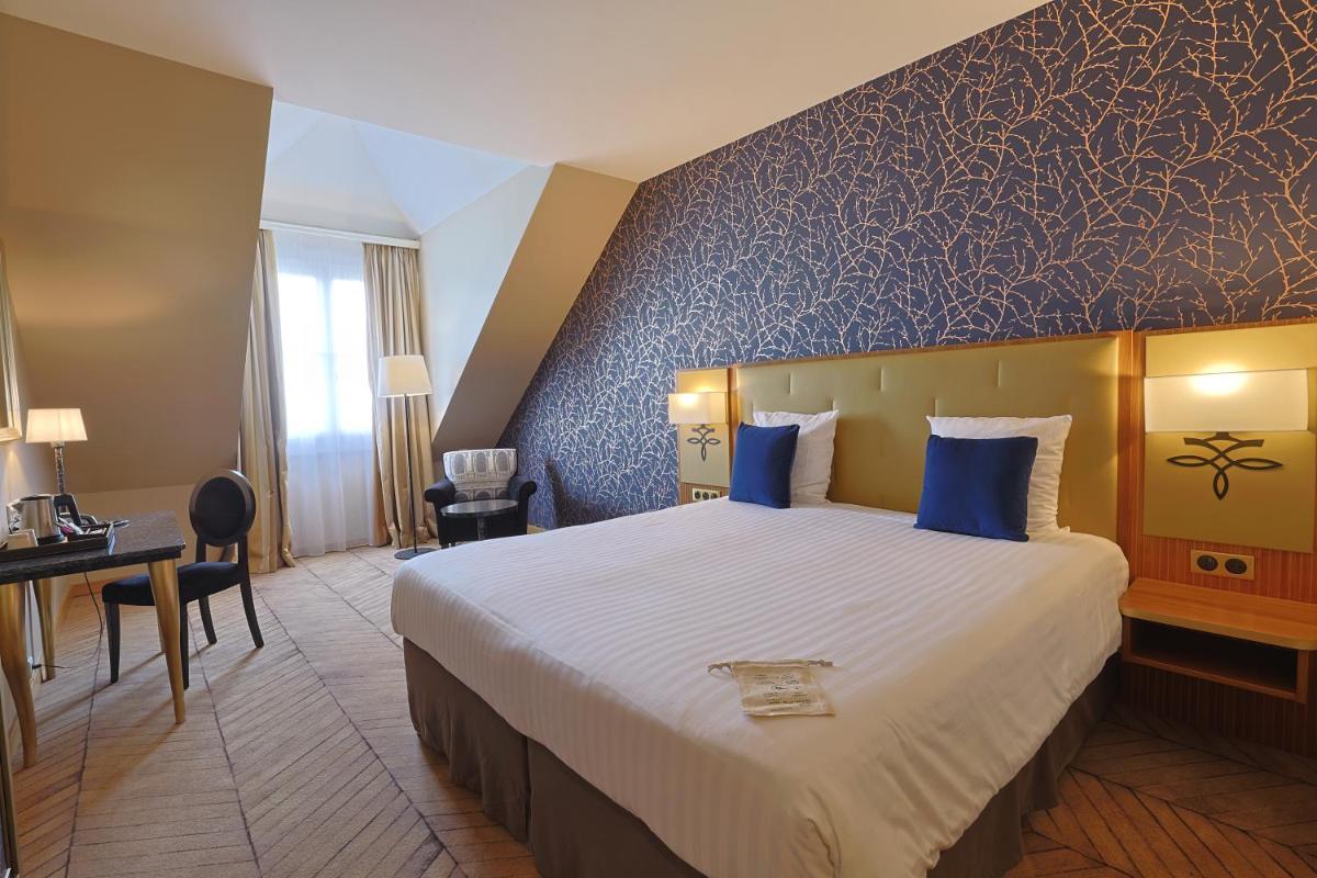 Un ou plusieurs lits dans un hébergement de l'établissement Dream Castle Hotel Marne La Vallee