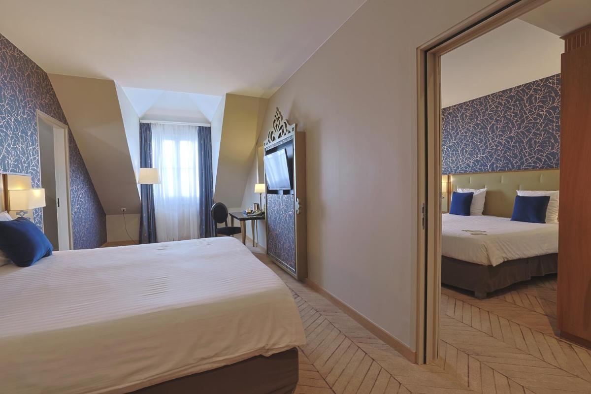 Un ou plusieurs lits dans un hébergement de l'établissement Dream Castle Hotel Marne La Vallee