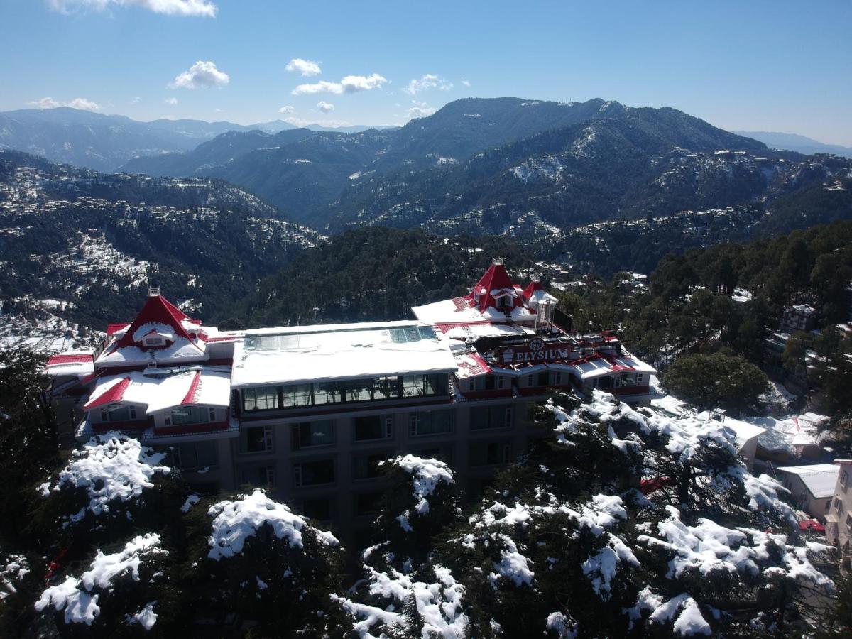 a building on top of a snow covered mountain at WelcomHeritage Elysium Resort & Spa in Shimla