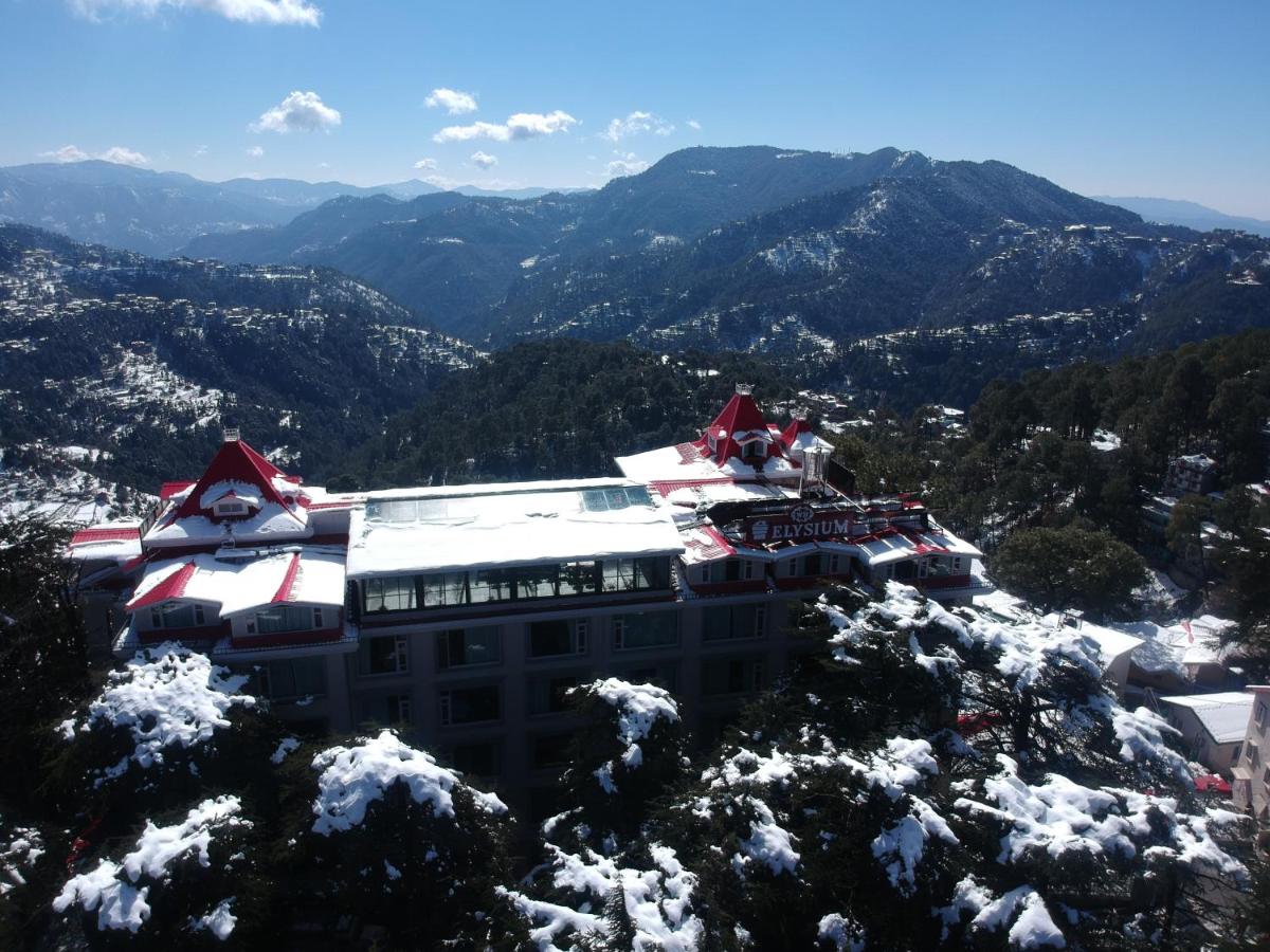 a building on top of a snow covered mountain at WelcomHeritage Elysium Resort & Spa in Shimla