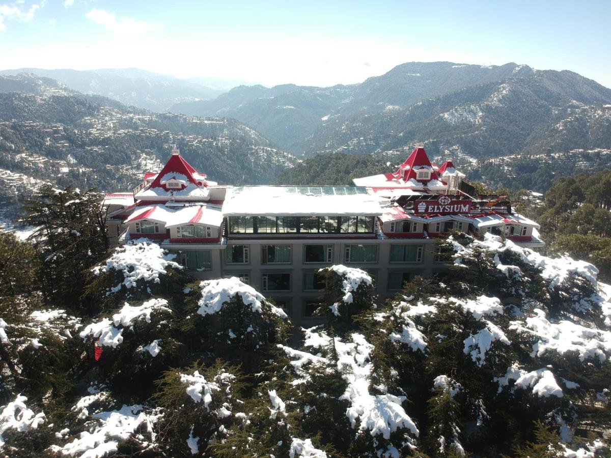 a building on top of a snow covered mountain at WelcomHeritage Elysium Resort & Spa in Shimla