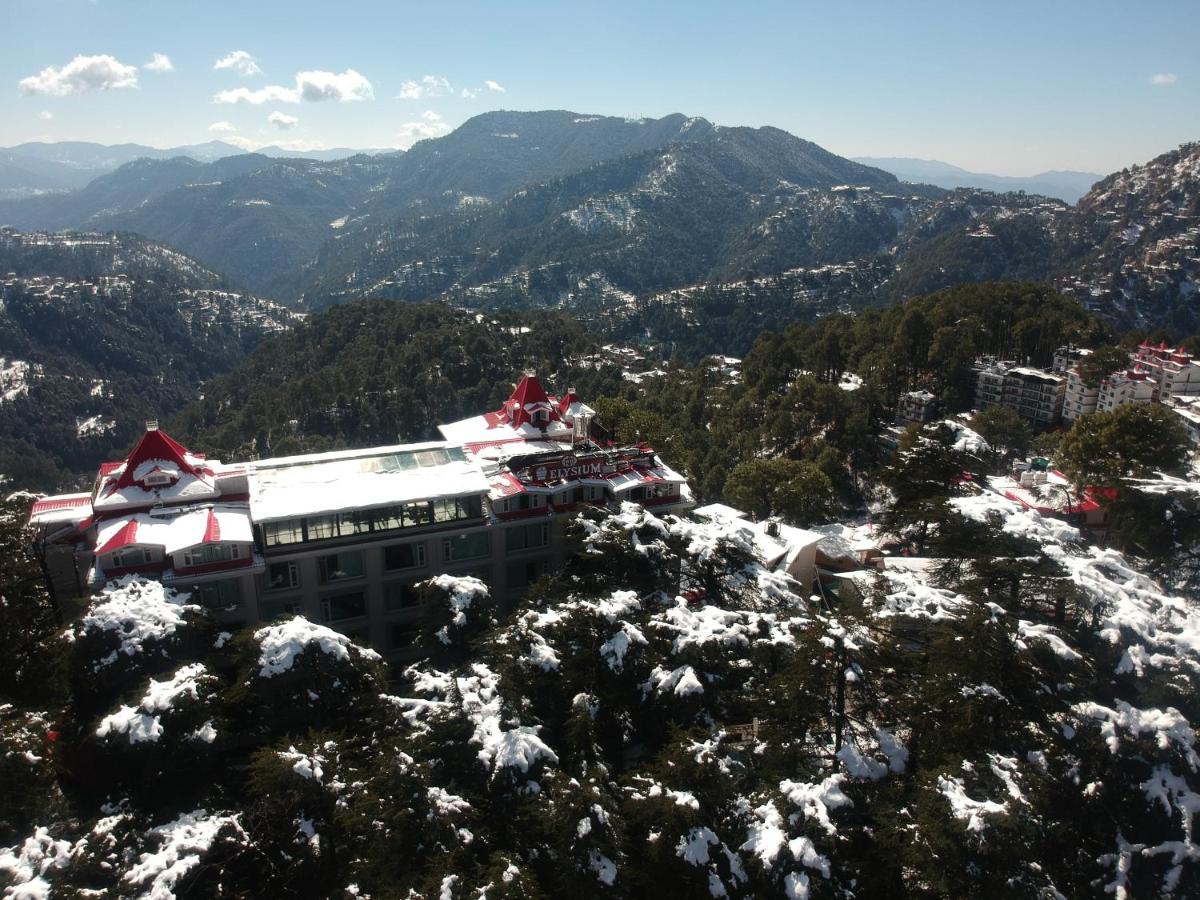 a building on top of a snow covered mountain at WelcomHeritage Elysium Resort & Spa in Shimla