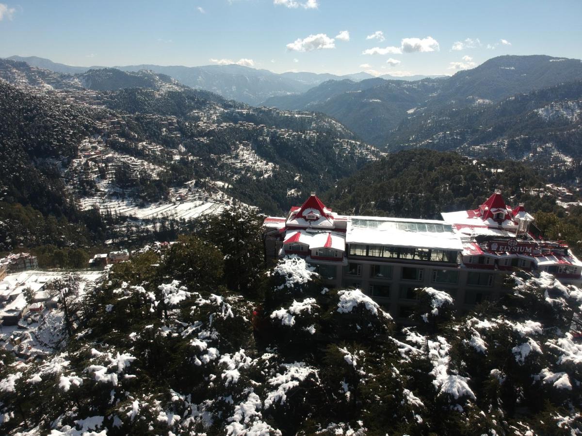 a building on top of a snow covered mountain at WelcomHeritage Elysium Resort & Spa in Shimla