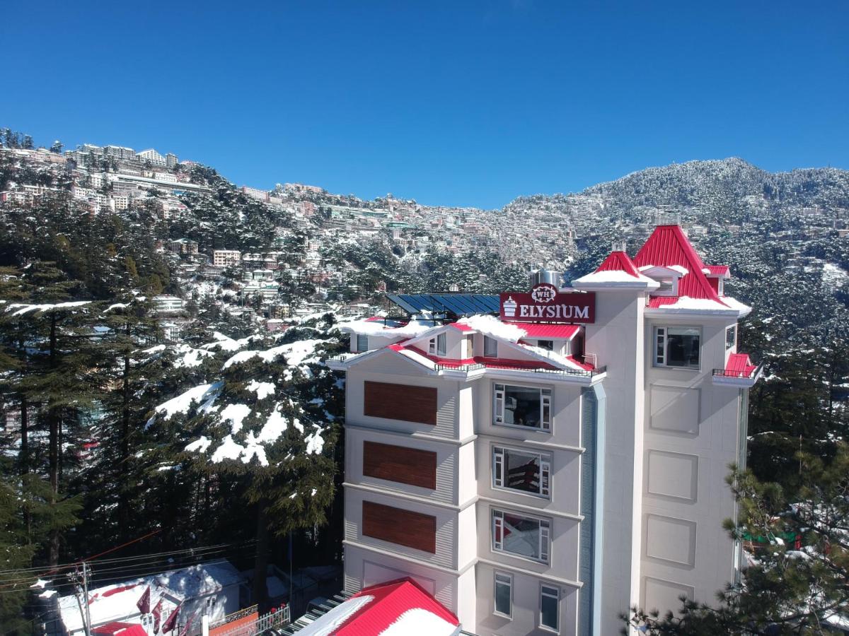 a white building with a red roof on a mountain at WelcomHeritage Elysium Resort & Spa in Shimla