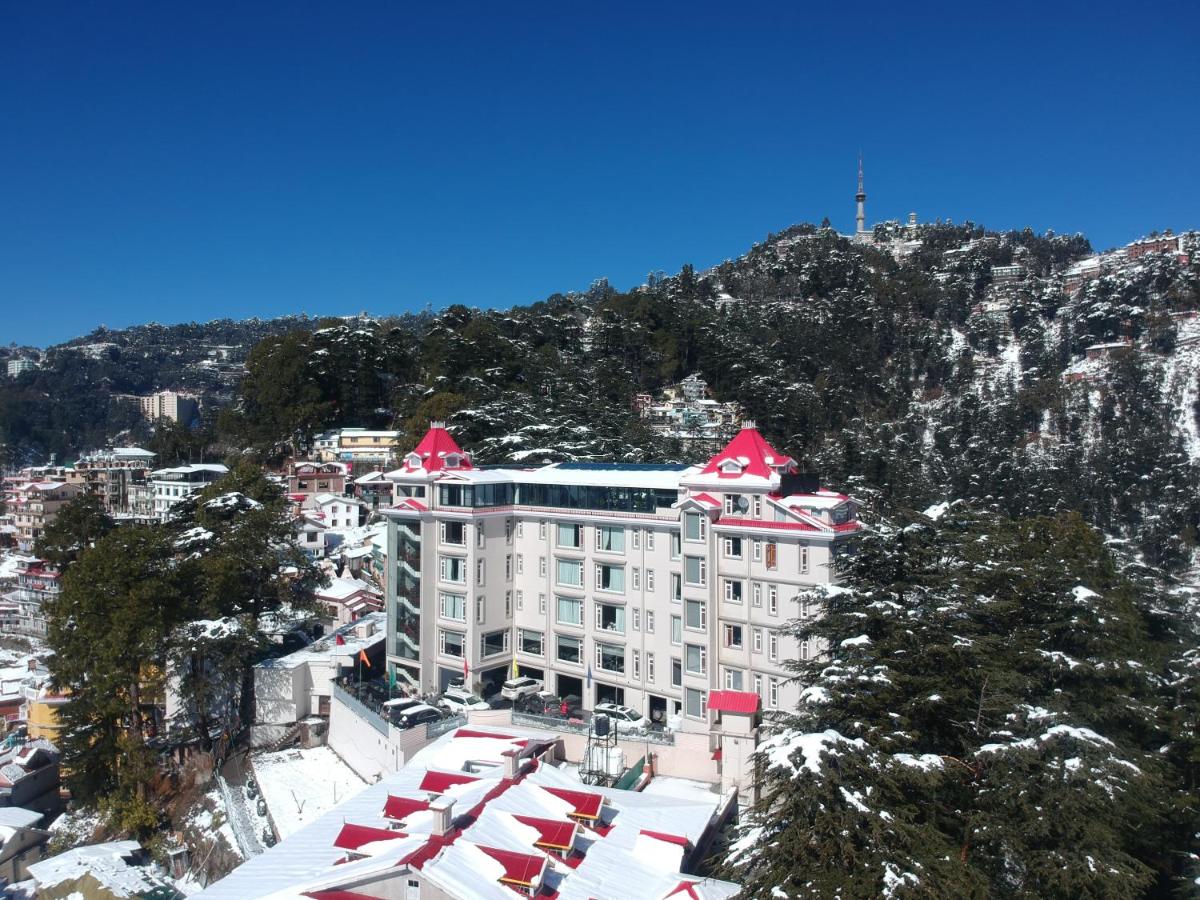 a large building with red roofs on a mountain at WelcomHeritage Elysium Resort & Spa in Shimla