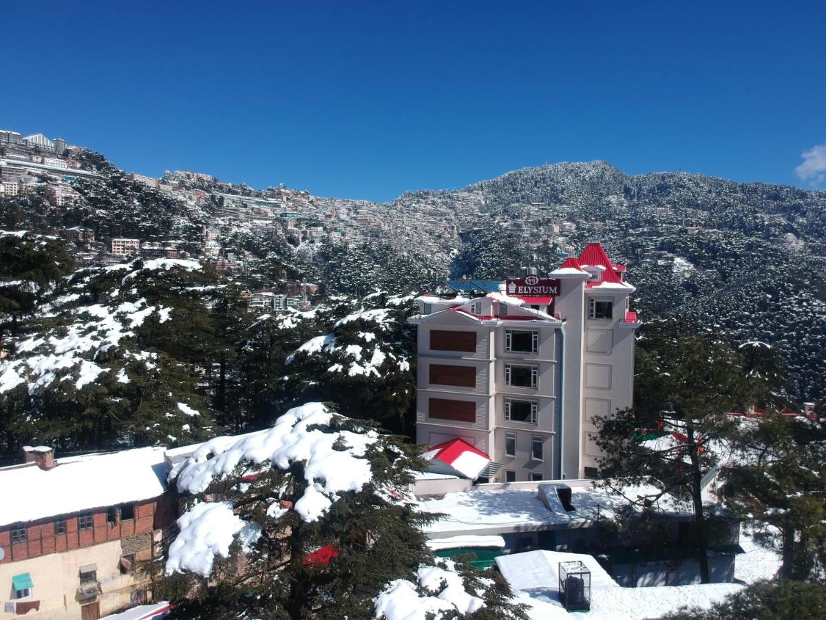 a building with a red roof in the snow at WelcomHeritage Elysium Resort & Spa in Shimla