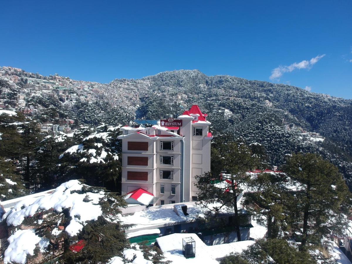a building on top of a mountain with snow at WelcomHeritage Elysium Resort & Spa in Shimla