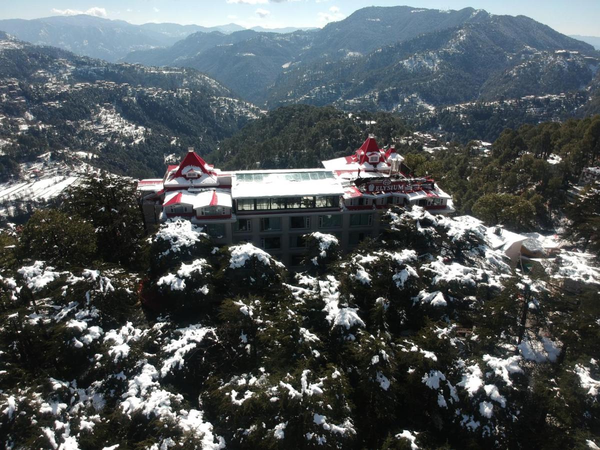a building on top of a snow covered mountain at WelcomHeritage Elysium Resort & Spa in Shimla