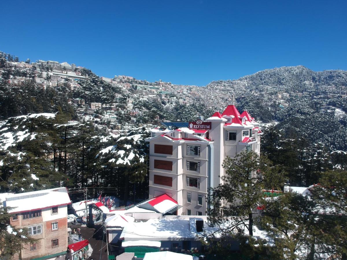 a white building with a red roof on a mountain at WelcomHeritage Elysium Resort & Spa in Shimla