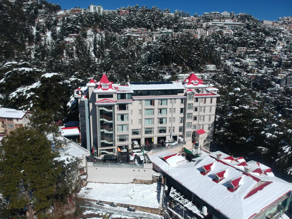 an aerial view of a building with snow on the roof at WelcomHeritage Elysium Resort & Spa in Shimla