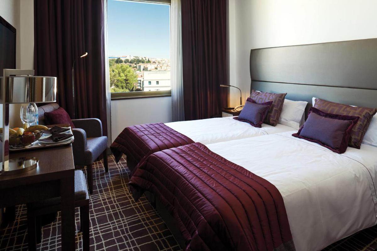 Uma cama ou camas num quarto em NEYA Lisboa Hotel