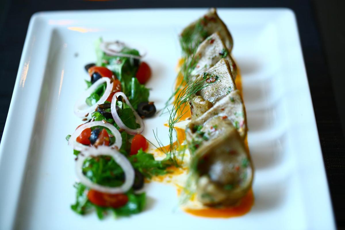 a white plate with some food on it at Vivanta Chennai IT Expressway OMR in Chennai