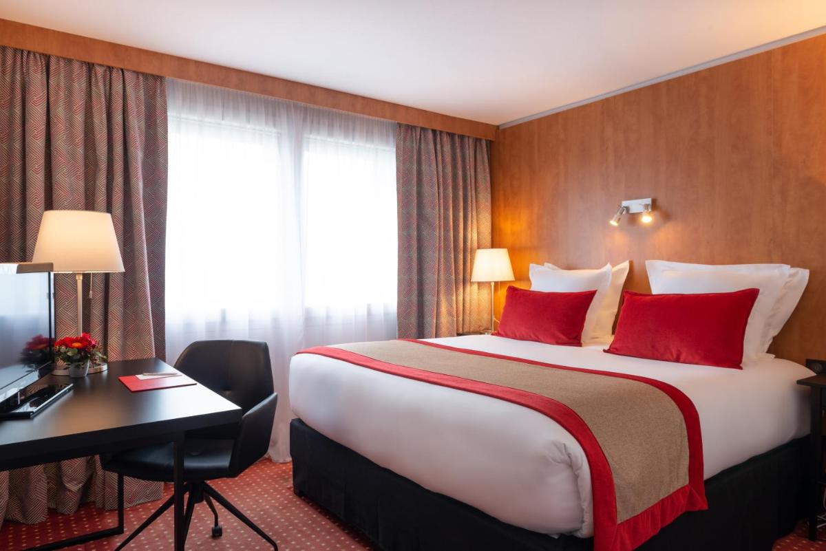 Un ou plusieurs lits dans un hébergement de l'établissement Le M & Spa Bordeaux Aéroport by Hôtels & Préférence